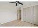 This bedroom features a modern ceiling fan, wood floors, neutral paint, and double closets at 5819 E Ludlow Dr, Scottsdale, AZ 85254