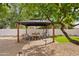 Charming backyard gazebo with comfortable seating and a cozy hammock, set amidst lush greenery and a brick pathway at 5819 E Ludlow Dr, Scottsdale, AZ 85254