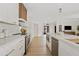 Well-lit kitchen with white cabinetry, modern appliances, and open layout to dining area at 5819 E Ludlow Dr, Scottsdale, AZ 85254