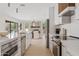 Elegant kitchen with stainless steel appliances and a view of the dining and living spaces at 5819 E Ludlow Dr, Scottsdale, AZ 85254