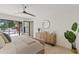 Relaxing main bedroom features a ceiling fan and glass door to the backyard at 5819 E Ludlow Dr, Scottsdale, AZ 85254