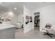 Serene bathroom with soaking tub, stylish tile, and open access to a walk-in closet at 6237 E Inglewood St, Mesa, AZ 85205