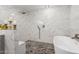 Bright bathroom with dual shower heads, mosaic tile flooring, white marble tiling, and soaking tub at 6237 E Inglewood St, Mesa, AZ 85205