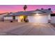 Single-story home featuring a two-car garage, desert landscaping, and covered front entry at 6237 E Inglewood St, Mesa, AZ 85205