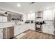 Bright kitchen featuring stainless steel appliances, white cabinetry, and wood flooring at 6237 E Inglewood St, Mesa, AZ 85205