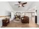 Bright living room featuring hardwood floors, ceiling fan, and comfortable seating area at 6237 E Inglewood St, Mesa, AZ 85205