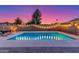 Inviting backyard featuring a sparkling pool with vibrant lighting and cozy hammock seating at 6237 E Inglewood St, Mesa, AZ 85205