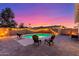 Relaxing backyard with a private pool, comfortable seating, ambient string lights, and pavers at 6237 E Inglewood St, Mesa, AZ 85205