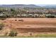 Vast land with tractor equipment; residential homes in background with mountain view at 6648 S 27Th Ave, Phoenix, AZ 85041