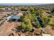 Aerial view of the home with mature trees, large workshop, and a private pond at 6648 S 27Th Ave, Phoenix, AZ 85041