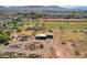 Expansive aerial view showing the property's acreage, outbuildings, and stunning mountain backdrop at 6648 S 27Th Ave, Phoenix, AZ 85041