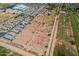 Aerial view featuring the property's expansive land, neighboring residences and fields, ideal for future development at 6648 S 27Th Ave, Phoenix, AZ 85041