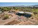 Wide aerial shot of open-air metal buildings with mountain views and equipment at 6648 S 27Th Ave, Phoenix, AZ 85041