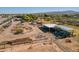 Wide aerial shot of open-air metal buildings with mountain views and equipment at 6648 S 27Th Ave, Phoenix, AZ 85041