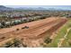 Vast land with tractor equipment; residential homes in background with mountain view at 6648 S 27Th Ave, Phoenix, AZ 85041