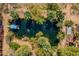 Overhead shot of private pond featuring a dock, mature trees, and aquatic landscaping at 6648 S 27Th Ave, Phoenix, AZ 85041