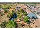 Scenic aerial shot showing the property's pond, mature trees, and nearby large outbuilding, near modern residences at 6648 S 27Th Ave, Phoenix, AZ 85041