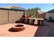 This backyard features a built in pizza oven, brick fire pit, and a paved seating area at 6834 E Culver St, Mesa, AZ 85207