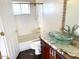 Bathroom featuring a glass bowl sink, granite counters, and wood cabinets at 6834 E Culver St, Mesa, AZ 85207