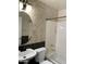 Bathroom featuring sink, toilet, and bathtub with diamond patterned tiles on the wall at 6834 E Culver St, Mesa, AZ 85207