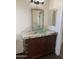 Bathroom featuring a glass bowl sink, granite counters, and wood cabinets at 6834 E Culver St, Mesa, AZ 85207