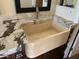 Close up of travertine sink with elegant countertop and wood cabinet at 6834 E Culver St, Mesa, AZ 85207