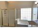 Bright bathroom showcasing a shower, glass block window, and granite countertop at 6834 E Culver St, Mesa, AZ 85207