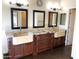 Bathroom features double sinks, marble countertops, and wood cabinetry at 6834 E Culver St, Mesa, AZ 85207