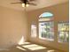 Bright bedroom with arched window, neutral paint, and carpeted floors at 6834 E Culver St, Mesa, AZ 85207