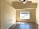 Bedroom featuring wood laminate flooring, ceiling fan, and natural light from the window at 6834 E Culver St, Mesa, AZ 85207