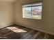 Bedroom with wood laminate flooring and a window view of the neighborhood at 6834 E Culver St, Mesa, AZ 85207