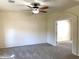 Neutral bedroom featuring soft carpet, ceiling fan, and open doorway at 6834 E Culver St, Mesa, AZ 85207