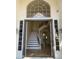 Elegant entryway with a curved staircase and a large window above the door, showcasing a bright and welcoming foyer at 6834 E Culver St, Mesa, AZ 85207