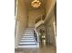 Elegant foyer with a curved staircase, decorative iron railing, and high ceilings at 6834 E Culver St, Mesa, AZ 85207