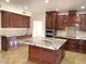 Gourmet kitchen features custom cabinetry, granite countertops, and a large center island at 6834 E Culver St, Mesa, AZ 85207