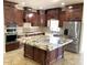 Gourmet kitchen features custom cabinetry, granite countertops, stainless appliances and a large island at 6834 E Culver St, Mesa, AZ 85207