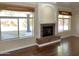 Inviting living room featuring wood floors, fireplace, and sun-filled windows at 6834 E Culver St, Mesa, AZ 85207