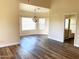 Open-concept living room with chandelier lighting and an adjacent bathroom at 6834 E Culver St, Mesa, AZ 85207