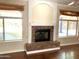 Bright living room with brick fireplace, wood floors, and natural light at 6834 E Culver St, Mesa, AZ 85207