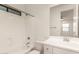 Bright bathroom featuring a shower-tub combination and a single sink vanity with a large mirror at 717 E Deer Creek Rd, Phoenix, AZ 85048