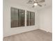 Bright bedroom featuring plank flooring, neutral walls, and natural light from large windows at 717 E Deer Creek Rd, Phoenix, AZ 85048