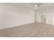 Spacious bedroom featuring neutral wall paint, wood-style floors, and modern ceiling fan at 717 E Deer Creek Rd, Phoenix, AZ 85048