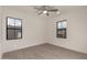 Bright bedroom featuring two windows, a ceiling fan, and wood-look flooring at 717 E Deer Creek Rd, Phoenix, AZ 85048