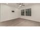 Bright bedroom featuring plank flooring, neutral walls, and a TV mount at 717 E Deer Creek Rd, Phoenix, AZ 85048