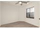 Bright bedroom featuring a window and a ceiling fan at 717 E Deer Creek Rd, Phoenix, AZ 85048