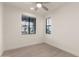 Cozy bedroom featuring wood-style floors, neutral wall paint, and views from two windows at 717 E Deer Creek Rd, Phoenix, AZ 85048