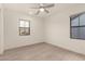 Bedroom featuring wood-style floors, neutral wall paint, recessed lighting, and two windows at 717 E Deer Creek Rd, Phoenix, AZ 85048