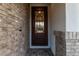 Elegant front door featuring decorative ironwork and brick surround at 717 E Deer Creek Rd, Phoenix, AZ 85048