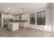 Spacious kitchen with white cabinetry, stainless steel appliances, and hardwood floors at 717 E Deer Creek Rd, Phoenix, AZ 85048