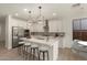 Modern kitchen with white cabinets, stainless steel appliances, and a large center island at 717 E Deer Creek Rd, Phoenix, AZ 85048